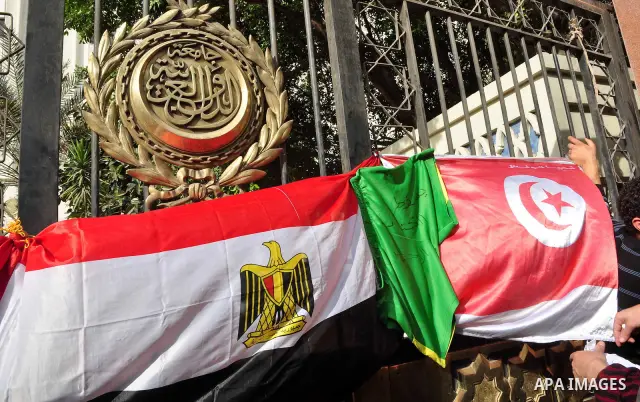 Protesters take part in a protest against Libyan Leader Moammar Gadhafi in front of the Arab league in Cairo, Egypt, Feb. 22, 2011. Protesters gathered at the protest against Gadhafi's crackdown on peaceful protesters in...