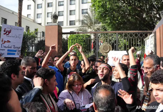 Protesters take part in a protest against Libyan Leader Moammar Gadhafi in front of the Arab league in Cairo, Egypt, Feb. 22, 2011. Protesters gathered at the protest against Gadhafi's crackdown on peaceful protesters in...
