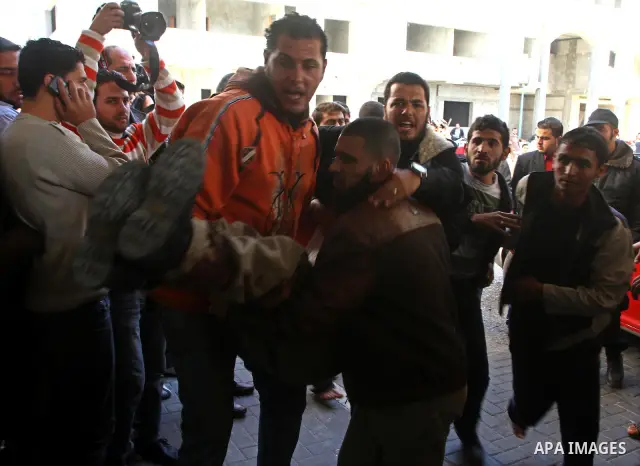 Palestinians carry a wounded man into al-Shefa hospital in Gaza City on Feb. 23, 2011. Eleven Palestinians were wounded Wednesday by Israeli artillery shelling in Gaza City, witnesses and medical sources said. Photo by A...