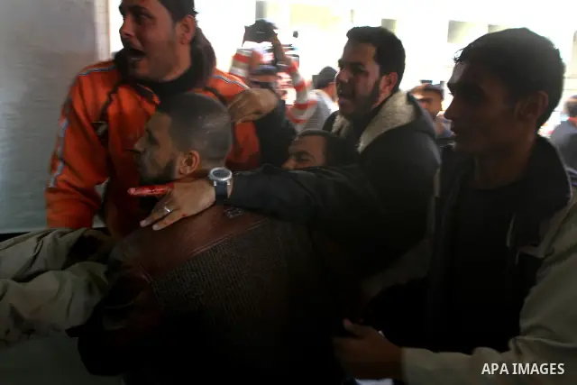 Palestinians carry a wounded man into al-Shefa hospital in Gaza City on Feb. 23, 2011. Eleven Palestinians were wounded Wednesday by Israeli artillery shelling in Gaza City, witnesses and medical sources said. Photo by A...