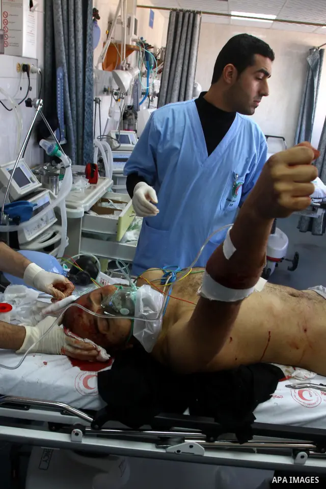 A wounded Palestinian man receives treatment into al-Shefa hospital in Gaza City on Feb. 23, 2011. Eleven Palestinians were wounded Wednesday by Israeli artillery shelling in Gaza City, witnesses and medical sources said...