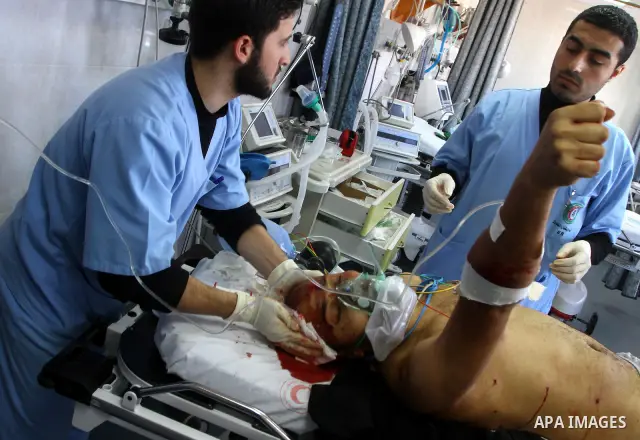 A wounded Palestinian man receives treatment into al-Shefa hospital in Gaza City on Feb. 23, 2011. Eleven Palestinians were wounded Wednesday by Israeli artillery shelling in Gaza City, witnesses and medical sources said...
