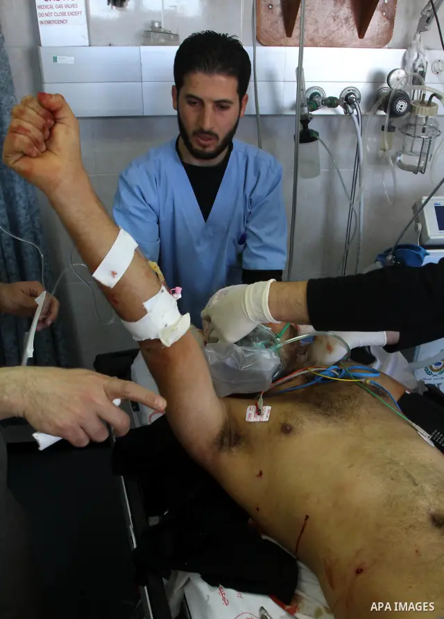 A wounded Palestinian man receives treatment into al-Shefa hospital in Gaza City on Feb. 23, 2011. Eleven Palestinians were wounded Wednesday by Israeli artillery shelling in Gaza City, witnesses and medical sources said...