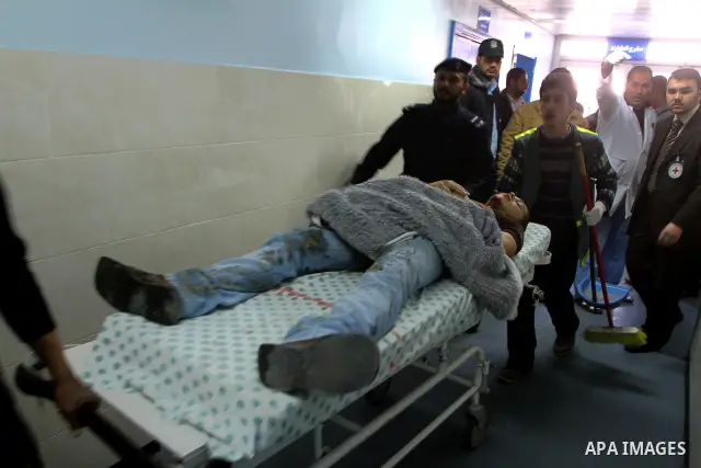 Palestinians carry a wounded man into al-Shefa hospital in Gaza City on Feb. 23, 2011. Eleven Palestinians were wounded Wednesday by Israeli artillery shelling in Gaza City, witnesses and medical sources said. Photo by A...