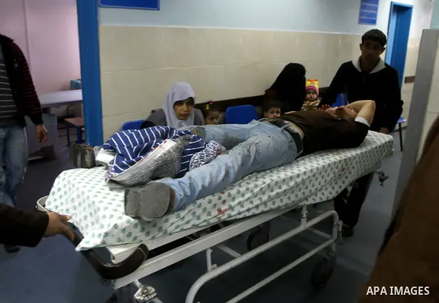 Palestinians carry a wounded man into al-Shefa hospital in Gaza City on Feb. 23, 2011. Eleven Palestinians were wounded Wednesday by Israeli artillery shelling in Gaza City, witnesses and medical sources said. Photo by A...