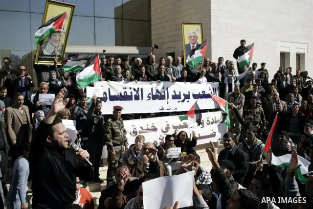 Palestinian protesters hold national flags and banners during a rally against the U.S. veto and calling for the national reconciliation in the West Bank city of Bethlehem, on Feb. 23, 2011. Photo by Najeh Hashlamoun