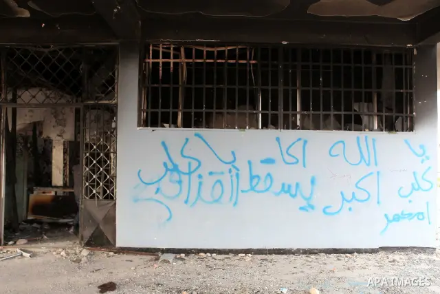 A man walks inside a burned police station in the eastern Libyan town of Derna on Feb. 23, 2011. Unrest shook Libya in recent days as government crackdowns on protesters have resulted in mass casualties, according to hum...