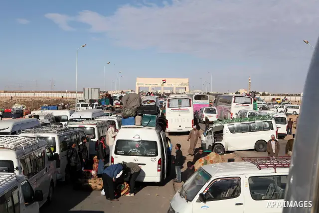 Egyptians, who have fled from Libya through the Salloum land port gate wait with their luggage,Wednesday, Feb. 23, 2011. An estimated 5,000 Egyptians have returned home from Libya by land, and about 10,000 more are waiti...