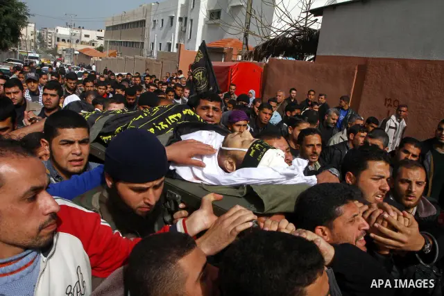 Palestinian mourners carry the body of Islamic Jihad militant Adel Jundia during his funeral in Gaza City on February 24, 2011, a day after he was killed by Israeli tank fire during clashes east of Gaza City. Ten other P...