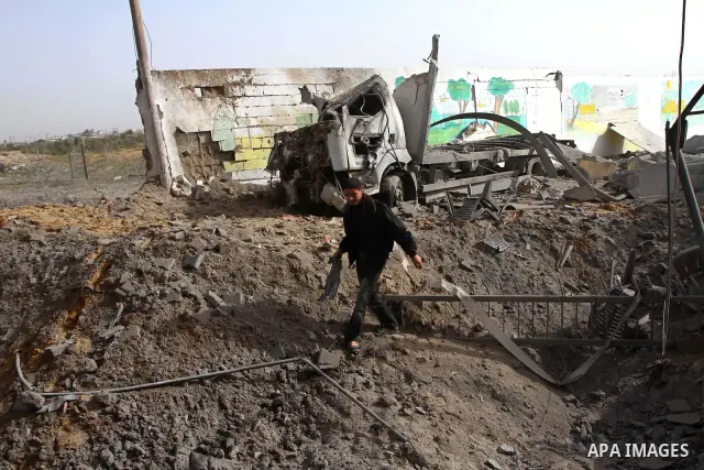 A Palestinian man surveys the damage the morning after an Israeli air strike in the Gaza Strip February 24, 2011. A rocket launched from the Gaza Strip landed in a residential street in the Israeli city of Beersheba Wedn...