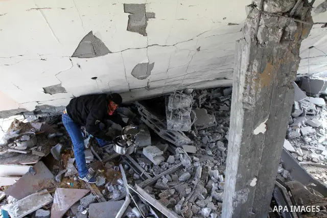 A Palestinian man surveys the damage the morning after an Israeli air strike in the Gaza Strip February 24, 2011. A rocket launched from the Gaza Strip landed in a residential street in the Israeli city of Beersheba Wedn...