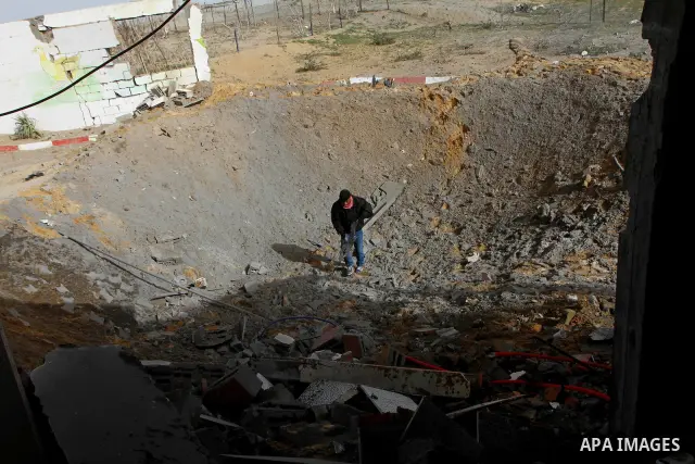 A Palestinian man surveys the damage the morning after an Israeli air strike in the Gaza Strip February 24, 2011. A rocket launched from the Gaza Strip landed in a residential street in the Israeli city of Beersheba Wedn...