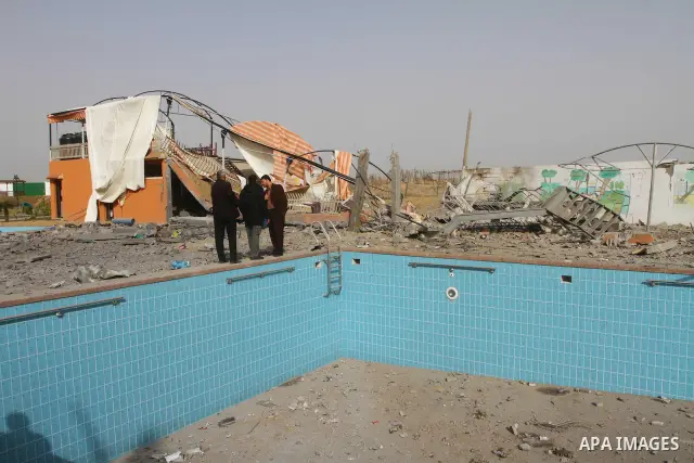 Palestinians inspect the damage at an abandoned swimming pool following an Israeli air strike in Gaza City, Thursday, Feb. 24 , 2011. Overnight, Israeli aircraft carried out airstrikes against targets in Hamas-controlled...