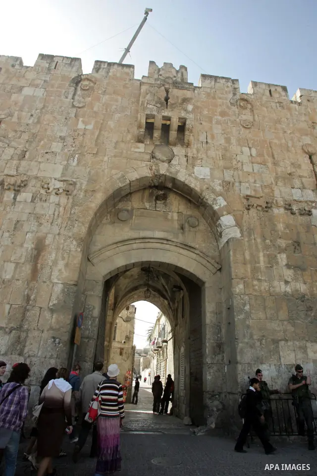 Palestinians and foreigners walk past the Lion Gate, just outside Jerusalem's Old City on Feb. 24, 2011. Photo by Mahfouz Abu Turk