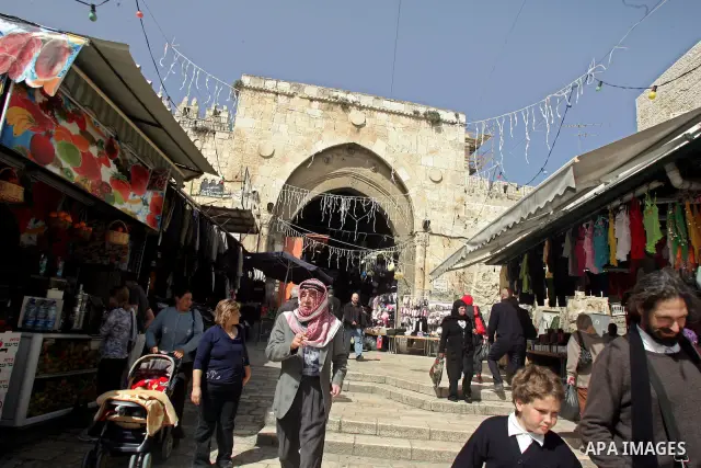 Palestinians and foreigners walk past Damascus Gate, just outside Jerusalem's Old City on Feb. 24, 2011. Photo by Mahfouz Abu Turk