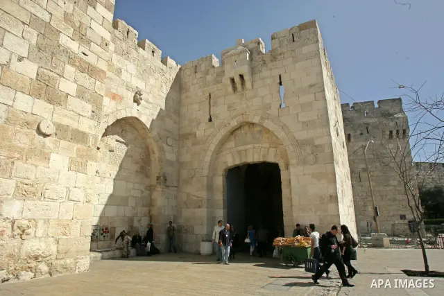 Palestinians walk past Jaffa gate, just outside Jerusalem's Old City on Feb. 24, 2011. Photo by Mahfouz Abu Turk