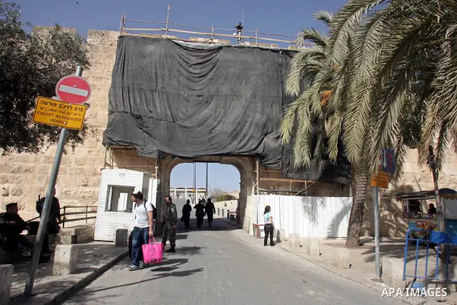 Palestinians and foreigners walk past the Dung gate, just outside Jerusalem's Old City on Feb. 24, 2011. Photo by Mahfouz Abu Turk