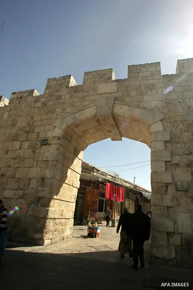 Palestinians walk past the New gate as known to Palestinians "Bab al-Jedid", just outside Jerusalem's Old City on Feb. 24, 2011. Photo by Mahfouz Abu Turk