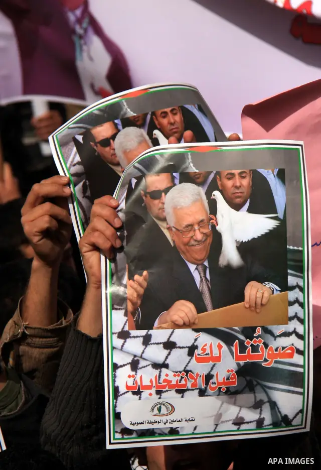 Palestinians hold placards of Palestinian President Mahmoud Abbas during a rally against the U.S. veto and calling for the national reconciliation in the West Bank city of Nablus, Thursday, Feb. 24, 2011. Photo by Wagdi...