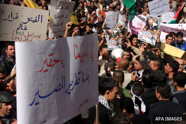 Palestinian protesters hold national flags and banners during a rally against the U.S. veto and calling for the national reconciliation in the West Bank city of Nablus, Thursday, Feb. 24, 2011. Photo by Wagdi Eshtayah