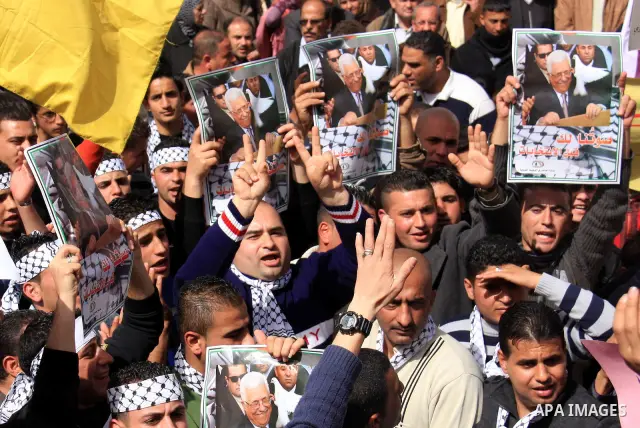 Palestinians hold placards of Palestinian President Mahmoud Abbas during a rally against the U.S. veto and calling for the national reconciliation in the West Bank city of Nablus, Thursday, Feb. 24, 2011. Photo by Wagdi...