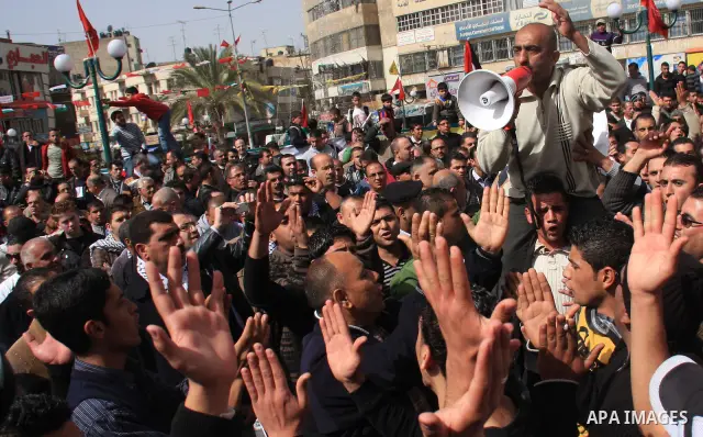 Palestinian protesters take part in a rally against the U.S. veto and calling for the national reconciliation in the West Bank city of Nablus, Thursday, Feb. 24, 2011. Photo by Wagdi Eshtayah