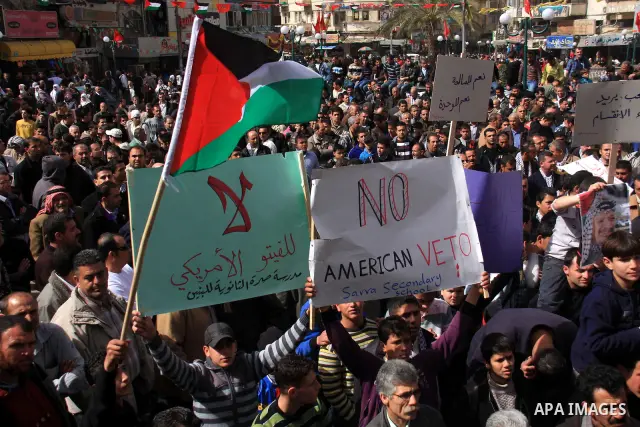 Palestinian protesters hold national flags and banners during a rally against the U.S. veto and calling for the national reconciliation in the West Bank city of Nablus, Thursday, Feb. 24, 2011. Photo by Wagdi Eshtayah