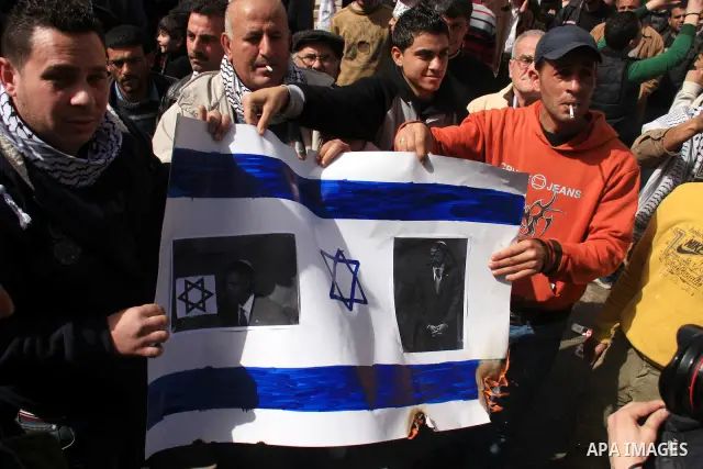 Palestinians take part in a rally against the U.S. veto and calling for the national reconciliation in the West Bank city of Nablus, Thursday, Feb. 24, 2011. Photo by Wagdi Eshtayah