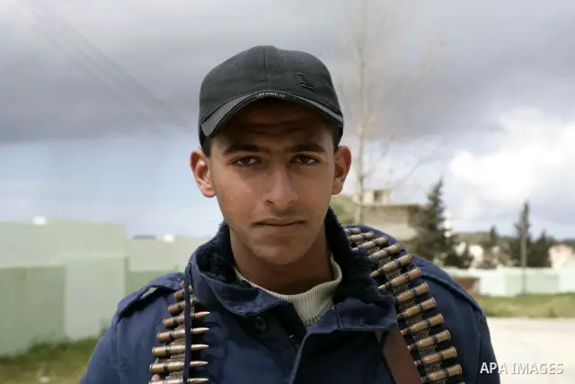 Anti-government protester holds a gun near a square where people are protesting in ALbedi city, Libya, February 24, 2011. Thousands of Libyans celebrated the liberation of the eastern city of Benghazi from the rule of Mu...