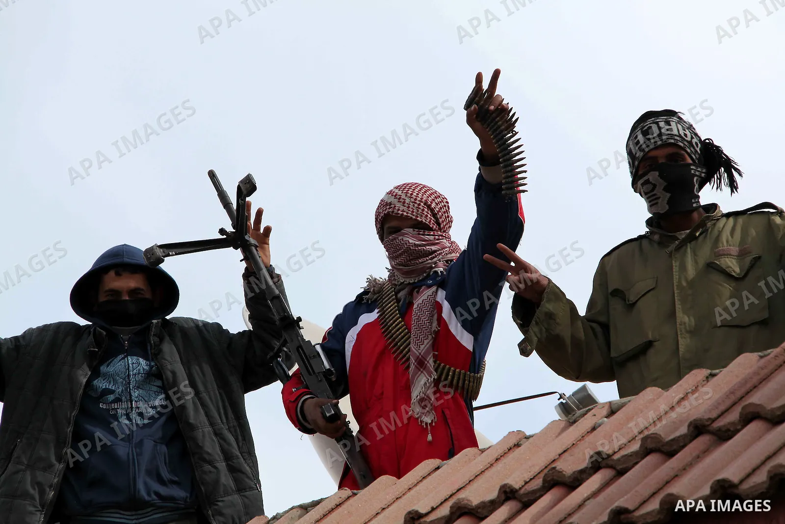 A Libyan gunman as he holds his automatic machine gun , in Albedia , Libya, on Thursday Feb. 24, 2011. A Libyan witness says a Libyan army unit has blasted a minaret of a mosque in a city west of Tripoli. The witness tel...