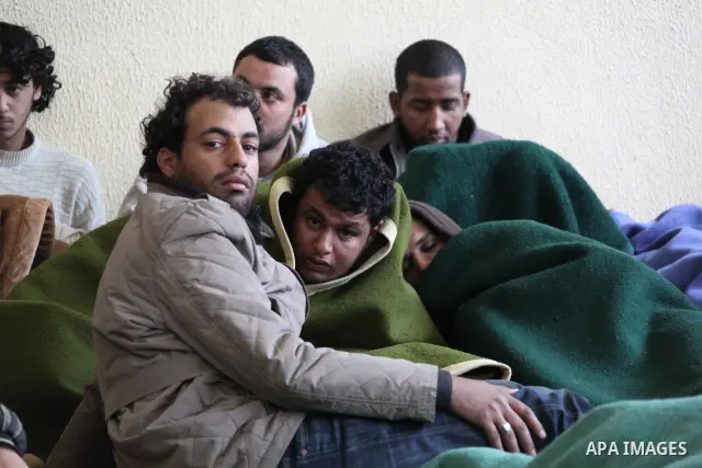 Suspected African mercenaries sit in a room in a school as they are held by anti-government protesters, in Albedia February 24, 2011. About a dozen people were being held in a school building who residents said were "mer...