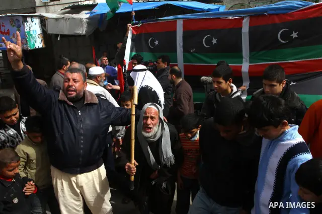 Palestinians take part in a protest to show solidarity with Libyan people, in Gaza city. Photo by Ashraf Amra