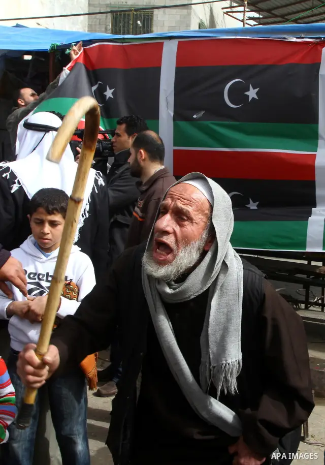 Palestinians take part in a protest to show solidarity with Libyan people, in Gaza city. Photo by Ashraf Amra