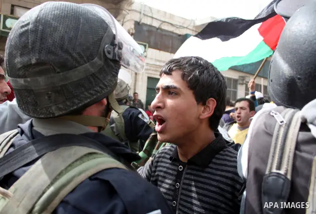 Israeli police officers try to push back Palestinian, Israeli and foreign activists during a protest against the continued closure of Shuhada street to Palestinians, in the West Bank city of Hebron 25 February 2011. The...