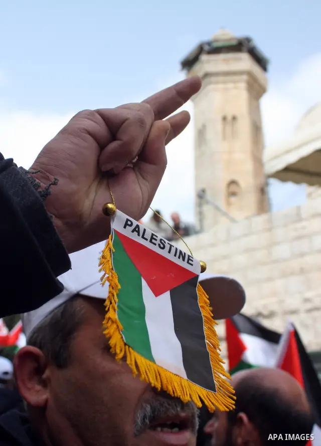 Palestinian, Israeli and foreign activists take part in a protest against the continued closure of Shuhada street to Palestinians, in the West Bank city of Hebron 25 February 2011. The activists gathered on Friday callin...