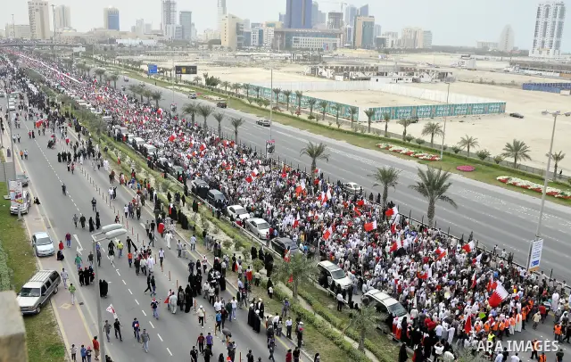 Protesters march on the streets of Manama, Bahrain, 25 February 2011. Tens of thousands of protesters marched in the Bahraini capital of Manama on 25 February to demand the resignation of the cabinet. It was the latest i...