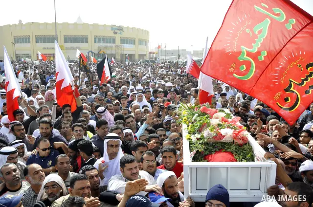 Anti-monarchy protesters and relatives accompany the coffin with the corpse of protester Abdul Redha Mohammed Hassan, 32, who was shot in the head by security forces while trying to march to Pearl Square, during the buri...