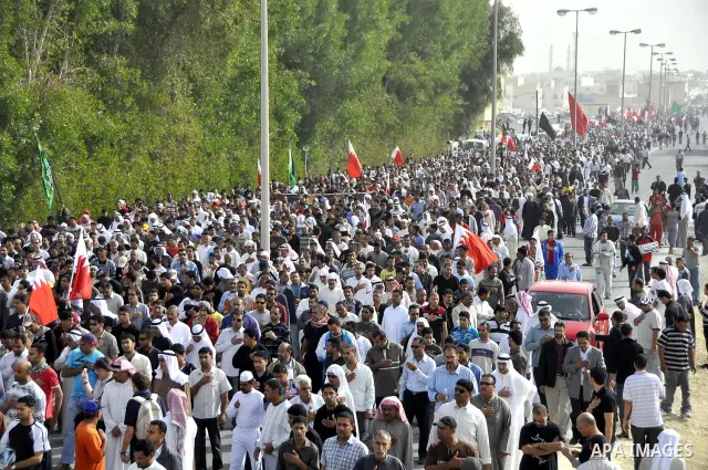 Anti-monarchy protesters and relatives accompany the coffin with the corpse of protester Abdul Redha Mohammed Hassan, 32, who was shot in the head by security forces while trying to march to Pearl Square, during the buri...