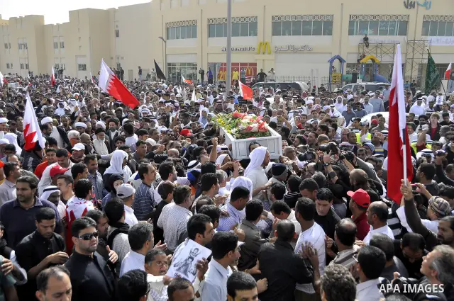 Anti-monarchy protesters and relatives accompany the coffin with the corpse of protester Abdul Redha Mohammed Hassan, 32, who was shot in the head by security forces while trying to march to Pearl Square, during the buri...
