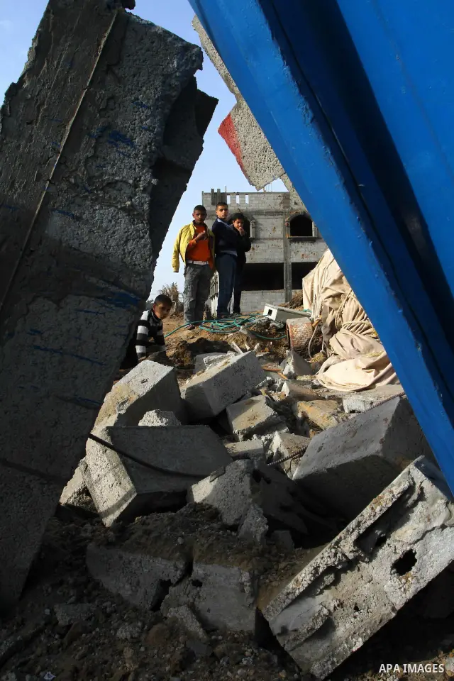 Palestinians inspect the damage left after a missile fired from an Israeli warplane hit Nusairat refugee camp, Central Gaza strip, Saturday, Feb. 26, 2011. The Israeli airforce attacked Friday night several targets in Kh...