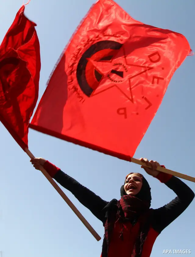 A Palestinian supporter of the Democratic Front for the Liberation of Palestine (DFLP) carries party flag during a rally celebrating 42 years since its founding in Gaza City, Saturday, Feb. 26, 2011. Founded in 1969 the...