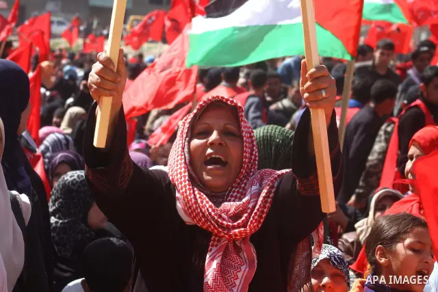 A Palestinian supporter of the Democratic Front for the Liberation of Palestine (DFLP) carries flag during a rally celebrating 42 years since its founding in Gaza City, Saturday, Feb. 26, 2011. Founded in 1969 the DFLP i...