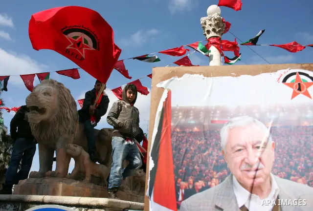Palestinian supporters of the Democratic Front for the Liberation of Palestine (DFLP) carry flags during a rally celebrating 42 years since its founding in the West Bank city of Ramallah, Saturday, Feb. 26, 2011. Founded...