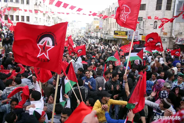 Palestinian supporters of the Democratic Front for the Liberation of Palestine (DFLP) carry flags during a rally celebrating 42 years since its founding in the West Bank city of Ramallah, Saturday, Feb. 26, 2011. Founded...