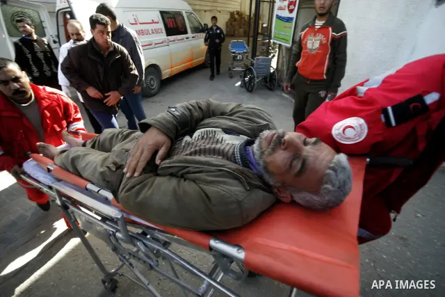A Palestinian man is wheeled to the hospital after he was wounded in Israeli air raid, in the southern Gaza Strip town of Rafah, on Feb. 26, 2011. Israeli aircraft attacked two military sites of the armed wing of the Isl...