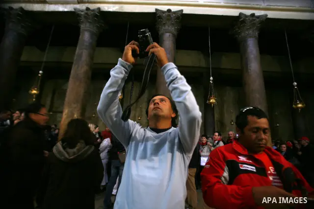 A member of Chilean miners who were rescued after 69 days of trapping underground in a collapsed mine in San Jose, visits the Church of the Nativity, the site revered as the birthplace of Jesus, in the West Bank city of...