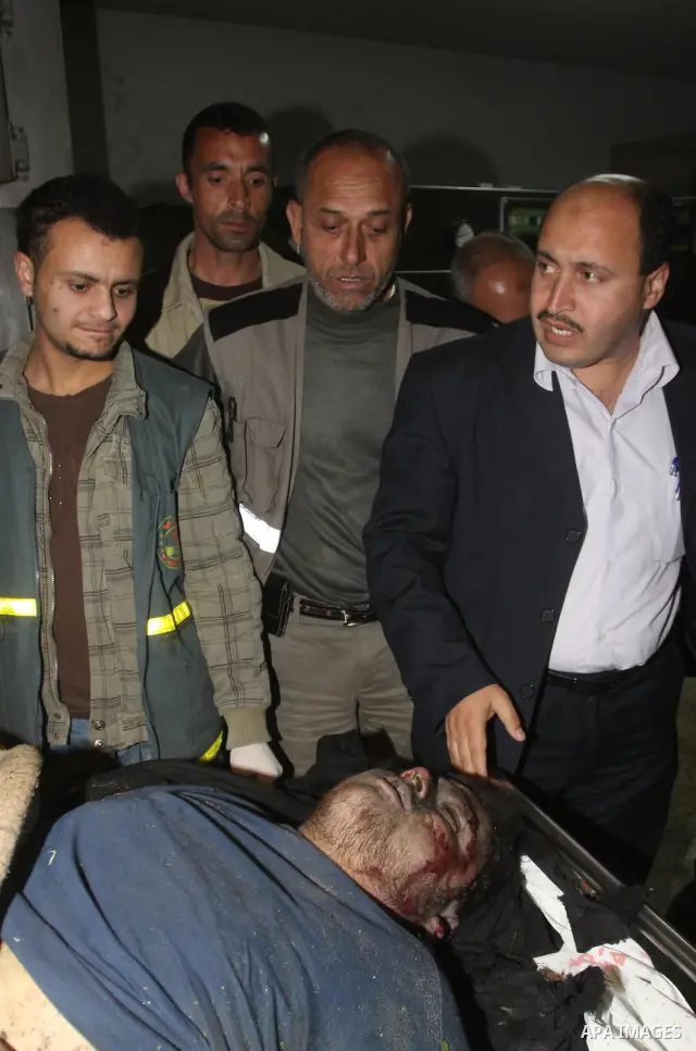 Palestinians gather around the body of a man at the mortuary of Al-Shifa hospital in Gaza City on February 27, 2011 after he was killed when an Israeli tank opened fire on a group of militants, medical sources and witnes...