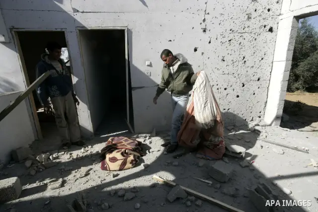 Palestinians inspect a house bombed by Israeli artillery, in the southern Gaza Strip town of Rafah on February 28, 2011. A Palestinian laborer was injured who was collecting gravel near the airport, while the family mira...