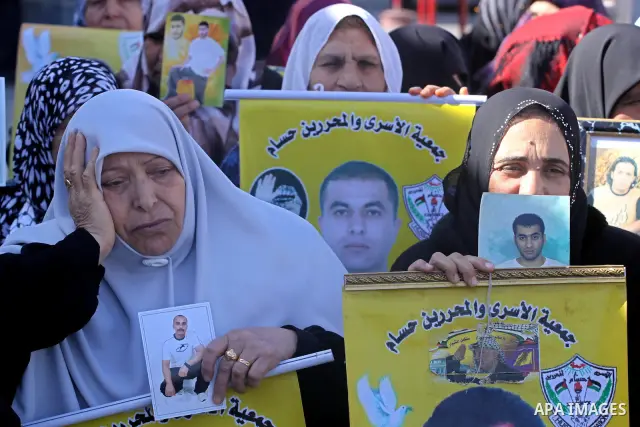Palestinian women hold pictures of jailed relatives during a protest calling for the release of Palestinian prisoners from Israeli jails at the Red Cross office in Gaza City on Feb. 28, 2011. Photo by Mohammed Asad