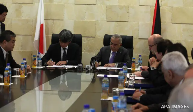 Palestinian prime minister Salam Fayyad, signs a project convention to establish a collection system and wastewater treatment in Jericho with the Japanese government, in the West Bank City of Ramallah on Feb. 28, 2011. P...